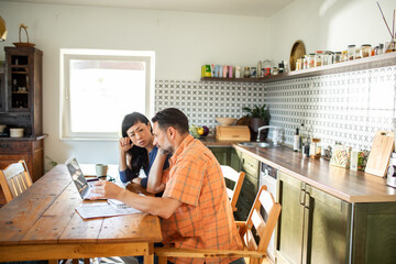 Couple managing finances online using credit card