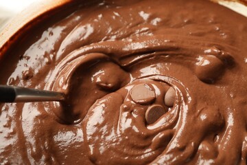 Melting chocolate chips for dough in bowl, closeup