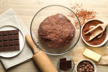 Chocolate dough and ingredients on wooden table, flat lay