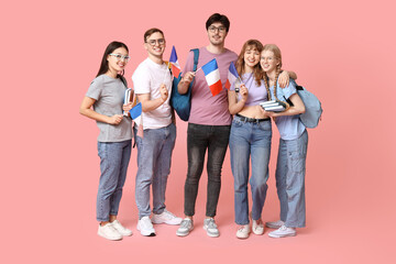 Obraz premium Group of students with French flags on pink background