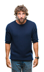 Fototapeta premium Handsome hispanic model man wearing winter sweater over isolated background afraid and shocked with surprise expression, fear and excited face.