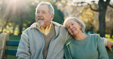 Senior couple, park bench and morning with hug, love and bonding together with health. Wellness,...