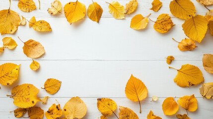 Autumn background made of yellow maple leaves on a white wooden tabletop, flat lay, copy space concept. 