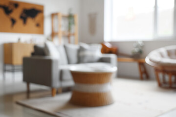 Blurred view of living room with sofa, table and world map on white wall