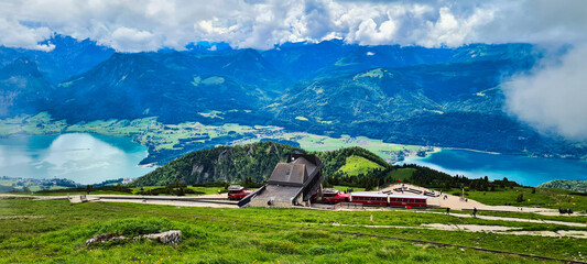 A stunning view from the Schafberg in Austria, showcasing the Schafberg Railway station with expansive vistas of the surrounding lakes and mountains. The Schafberg is a popular destination for hikers 