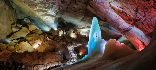 The Dachstein Mammoth Cave, located in Austria, features stunning ice formations and illuminated rock structures. This captivating underground cave system attracts visitors for its natural beauty, mak