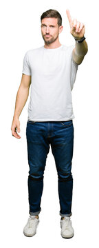 Handsome man wearing casual white t-shirt Pointing with finger up and angry expression