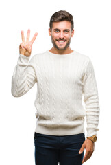 Young handsome man wearing winter sweater over isolated background showing and pointing up with fingers number three while smiling confident and happy.