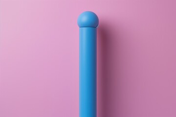 A light matte blue stick standing upright against a pastel pink background, creating a simple and...