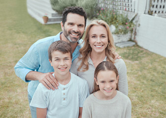 Family, portrait and smile at home for bonding, relax and support together with face on weekend. Parents, happy and children at backyard of house for care, leisure and love with fun break in Germany