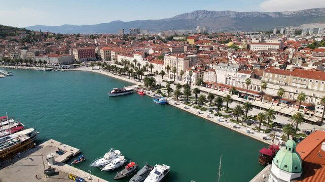 Aerial view of Split in Croatia. Riva promenade, famous travel destination in Split, establishing shot. Old town with historical red roof tiled buildings, Adriatic Sea