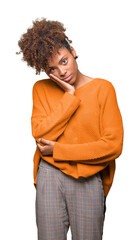 Beautiful young african american woman over isolated background thinking looking tired and bored with depression problems with crossed arms.