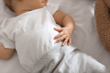 Cute little baby sleeping on bed in bedroom at home, closeup