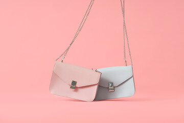 Stylish colourful bags on pink background