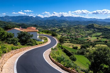 A rural road winding up a mountain, offering breathtaking views of the valleys and farms below