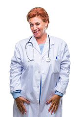Senior caucasian doctor woman wearing medical uniform over isolated background winking looking at...