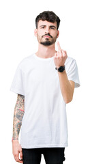 Young handsome man wearing white t-shirt over isolated background Showing middle finger, impolite and rude fuck off expression