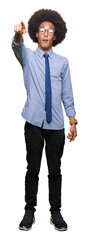 Young african american business man with afro hair wearing glasses Pointing with finger surprised...