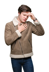 Young handsome man wearing winter coat over isolated background Touching forehead for illness and fever, flu and cold, virus sick