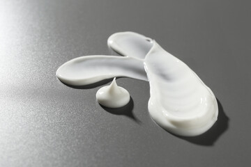Smears of cosmetic products on grey background