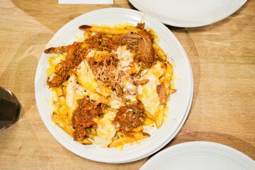 A plate of food with a lot of cheese and meat on it