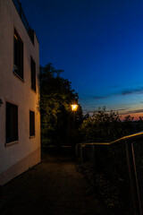 A street lamp on a small path in the evening at blue hour in Friedberg near Augsburg