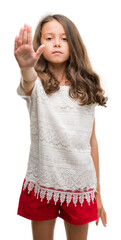Brunette hispanic girl doing stop sing with palm of the hand. Warning expression with negative and...