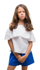 Brunette hispanic girl skeptic and nervous, frowning upset because of problem. Negative person.