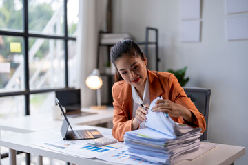 Businesswoman is searching for a document in a stack of paperwork