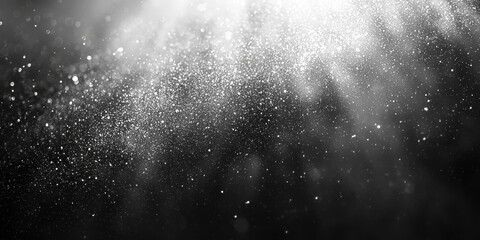 Obraz premium Sparkling silver glitter scattered on a black background.