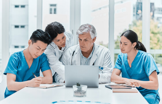 Medical group, laptop and planning in meeting for healthcare discussion, problem solving or training interns. Computer, hospital and team of doctors with nurses and mature mentor for schedule update