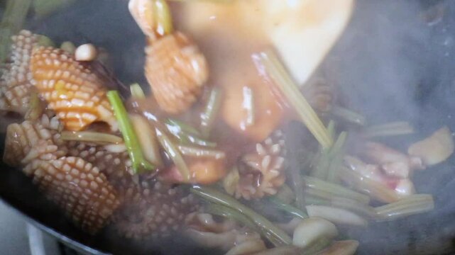 stir fry Squid seafood in wok, slow motion