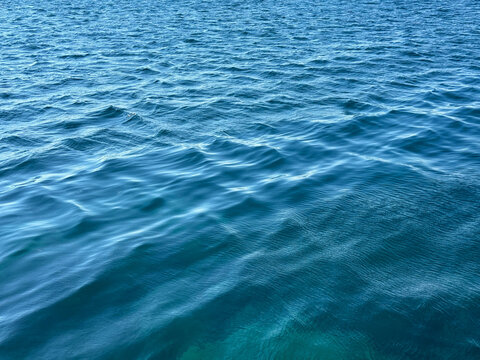 Blue ocean water rippled calm surface.
