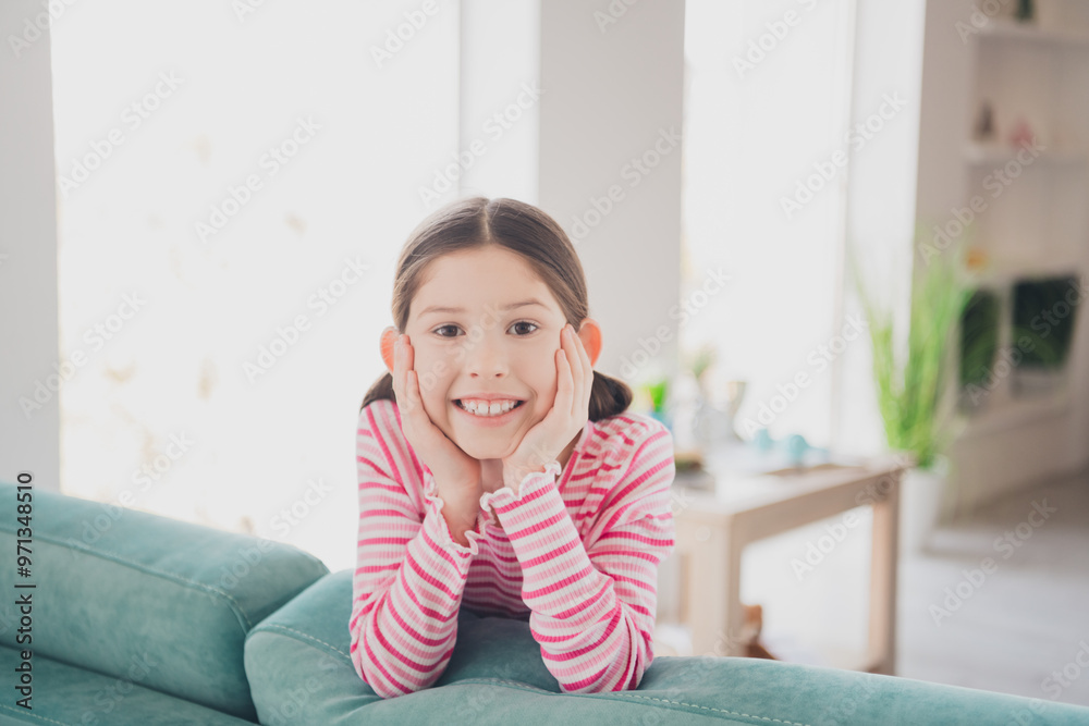 Canvas Prints Close up photo of young happy funny kid little brunette girl staying at home spending holidays lying on couch isolated in her room