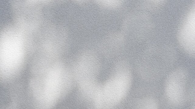 Gentle shadows play across a smooth surface, creating an artistic effect under bright, midday sunlight in an outdoor setting