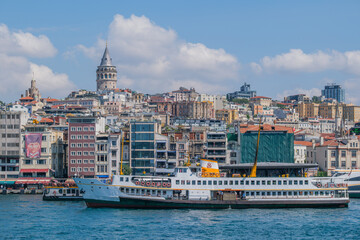 Fototapeta premium The Galata Tower and the Bosphorus offer a magnificent view with ferries
