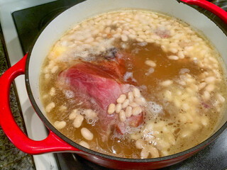 Bean Soup With Ham Cooking In A Ceramic Iron Pot