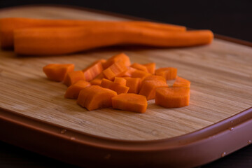 Fresh Organic Chopped Carrots on a Wooden Chopping Board Close-Up