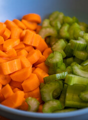  Chopped Carrots and Celery in a Blue Bowl for Soup Base Preparation Close-Up
