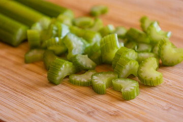 Fresh Organic Chopped Celery Sticks on a Wooden Chopping Board Close-Up