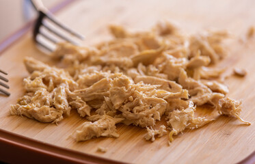  Boiled Shredded Chicken Breast Close-Up on Wooden Board