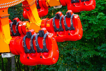 Empty red seats, extreme amusement park attraction rotation in a circle vertically, test launch