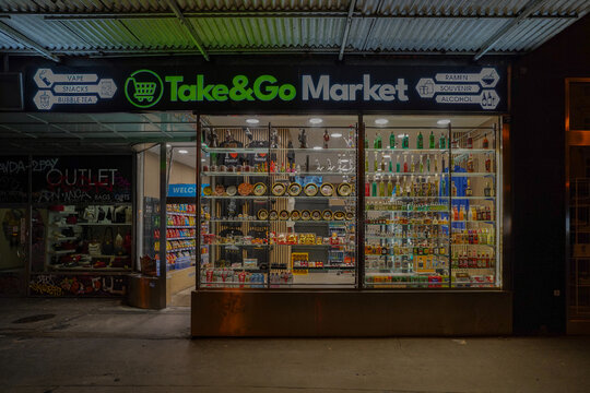 prague,czechia, 08 08 2024 : vitrine of minimarket at night