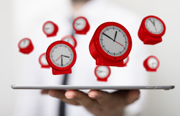 Floating Red Clocks Above a Tablet in a Business Setting