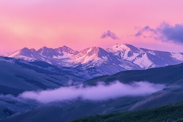 a mountain range covered in clouds and snow