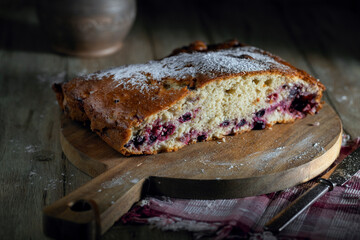 Homemade raspberry, currant and blueberry cake on a rustic table
