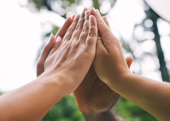 High five, diversity and hands of people in park for support, agreement and collaboration in...