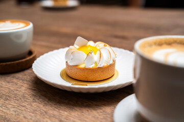 A close up of lemon tart with elegance decoration in a showcase of bakery or coffee shop, concept of sweet and dessert, juicy and freshness, delicious cake, modern and fancy decoration style