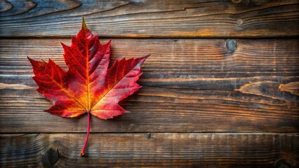 Obraz premium Vibrant red autumn leaf on rustic wooden table