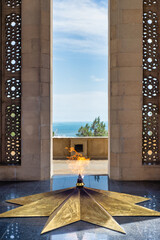The Eternal Flame burning at Shahidlar Monument in Baku, Azerbaijan. It is on a golden star and...